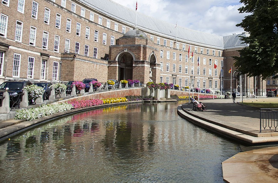 Bristol City Hall, a large curved Georgian building with a small moat and flowers in the foreground