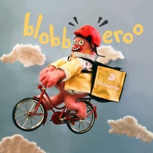 A Mr Blobby cycle courier pedals through the sky