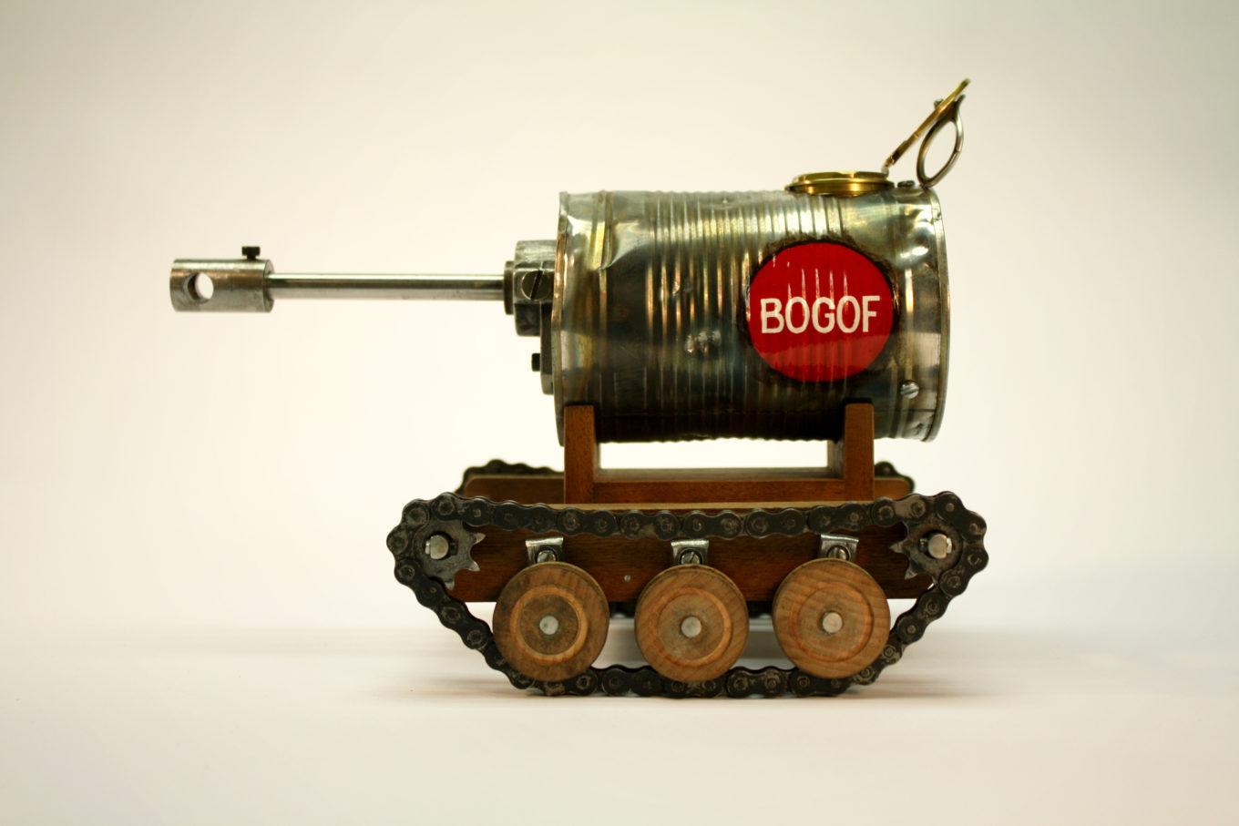 A toy tank made of wood and metal, the main body f the tank is a tin can.