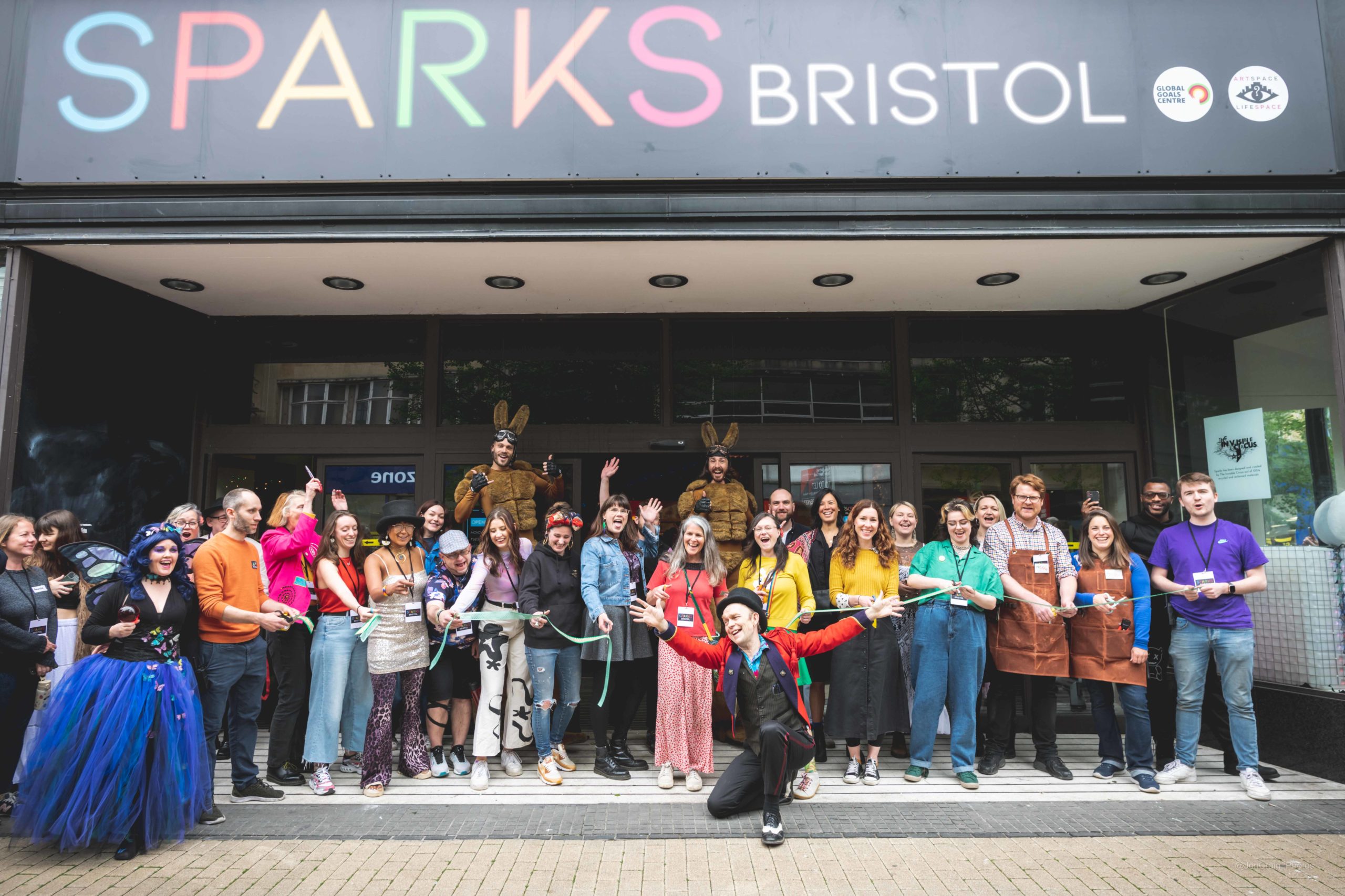 A group of people posing for a photo for the opening of Sparks department store