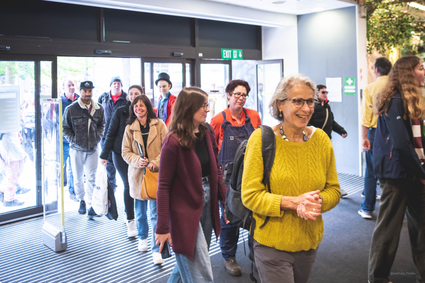 A group of people enter a shopping centre