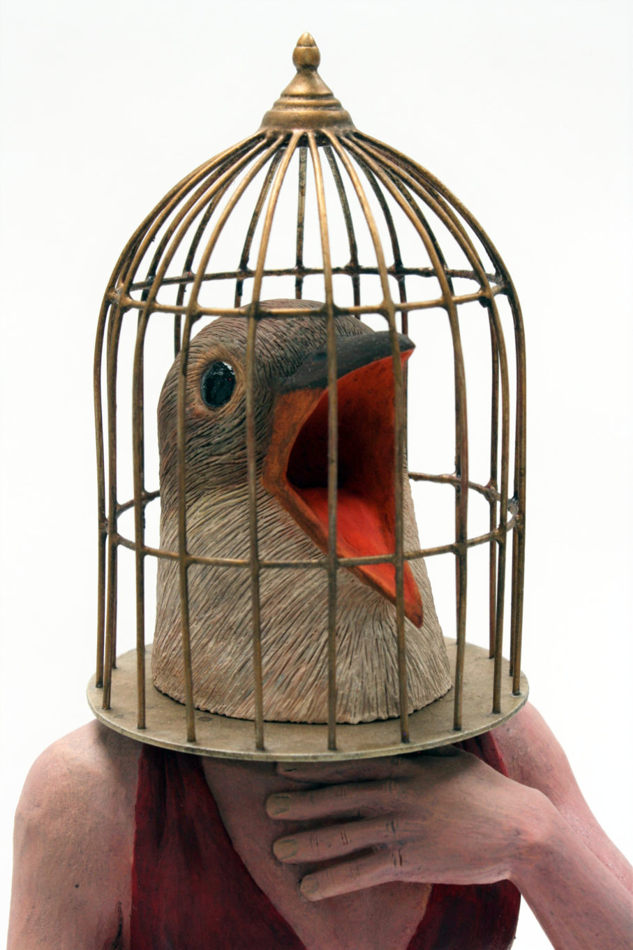 A person with a birds head trapped in a cage