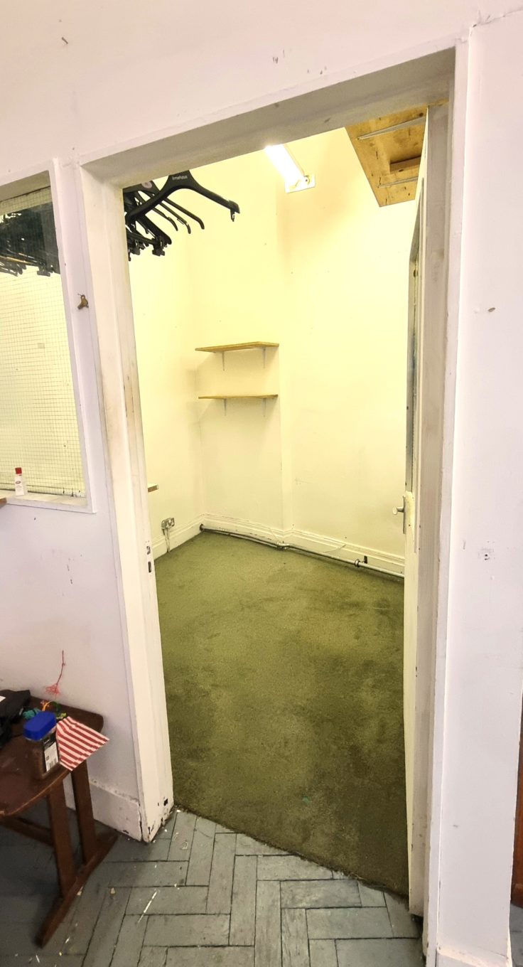 Photograph of a door leading to a small studio room