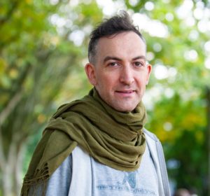 Profile photo of a white male with trees in the background